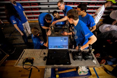 Members from team 3138 Innovators Robotics from a seven-school team in Dayton, Ohio work on their machine prior to a match duirng the FIRST Robotics Pittsburgh Regional competition.